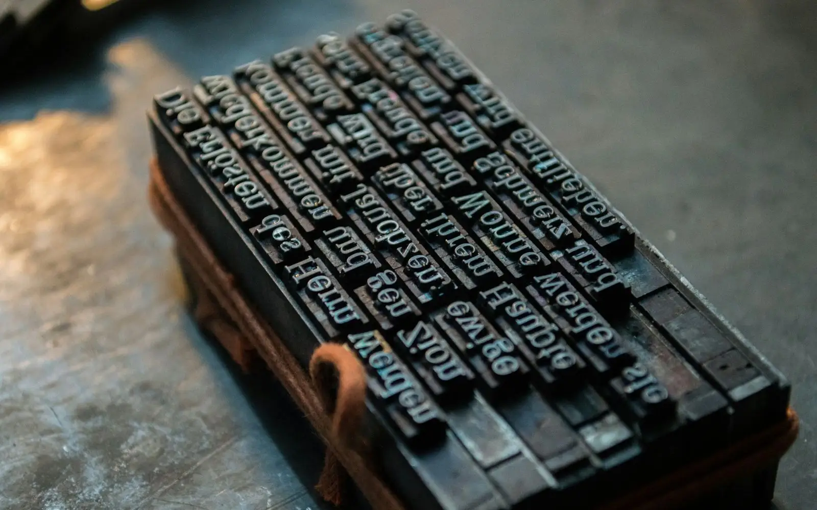 Lines of metal type locked up in a wooden frame, ready for proofing